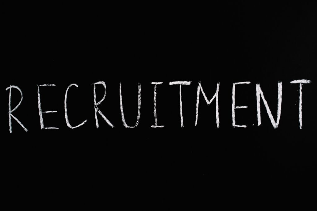 black background white chalk text recruitment